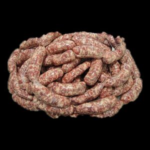 Salsicce fresche di maiale legate a mano, ammucchiate su fondo nero